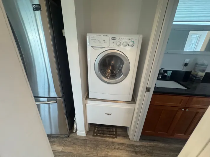  Yacht Photos Pics Washing machine and refrigerator in a tiny houseboat kitchen.