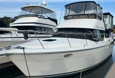 1991 Carver 33 Aft Cabin Motor Yacht docked, featuring sleek design and spacious cabin.