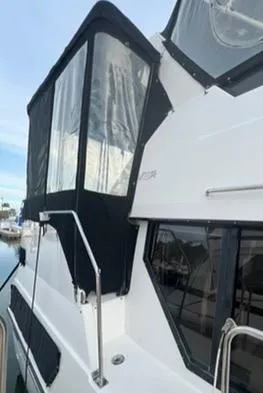 1991 Carver 33 Aft Cabin Motor Yacht with black canvas enclosure.