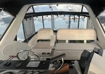 1991 Carver 33 Aft Cabin Motor Yacht interior with helm and seating area.