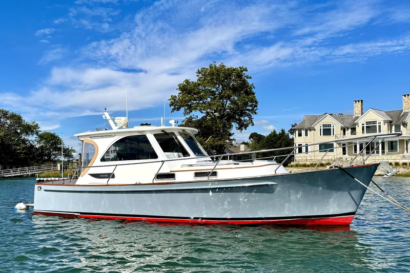 Belle Yacht Photos Pics 2007 Legacy Yachts 34 Sport Express on water near waterfront homes.