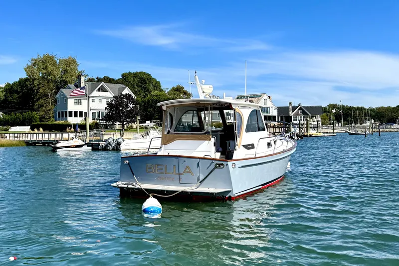 Belle Yacht Photos Pics 2007 Legacy Yachts 34 Sport Express moored in scenic harbor with waterfront homes.