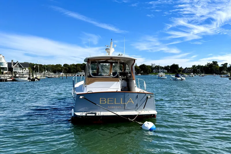 Belle Yacht Photos Pics 2007 Legacy Yachts 34 Sport Express on water, clear sky, marina background.