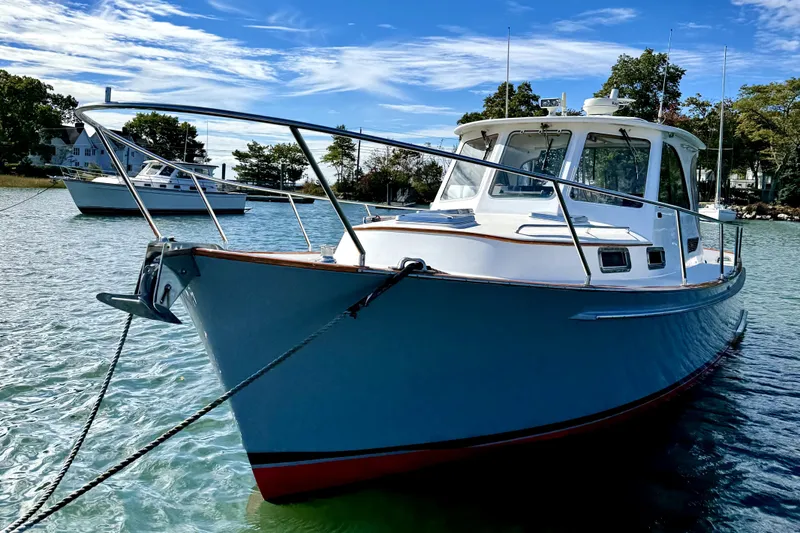 Belle Yacht Photos Pics 2007 Legacy Yachts 34 Sport Express in serene waters, showcasing elegant design.