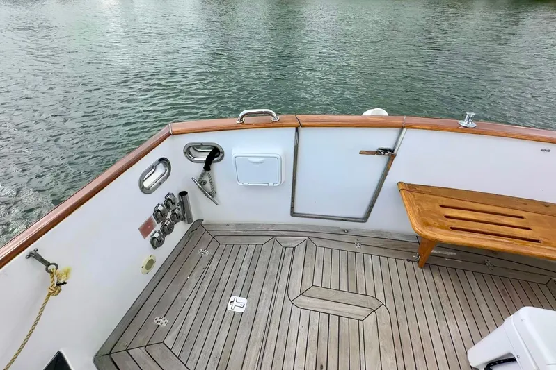 Belle Yacht Photos Pics 2007 Legacy Yachts 34 Sport Express deck with wooden bench and water view.