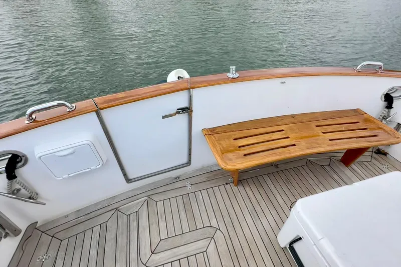 Belle Yacht Photos Pics 2007 Legacy Yachts 34 Sport Express deck with wooden bench and water view.