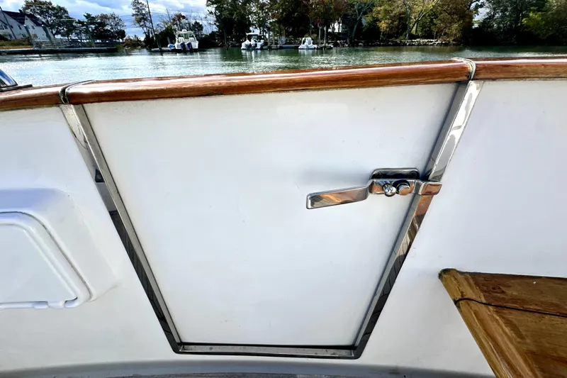 Belle Yacht Photos Pics 2007 Legacy Yachts 34 Sport Express, boat interior with polished metal handle and wooden trim.