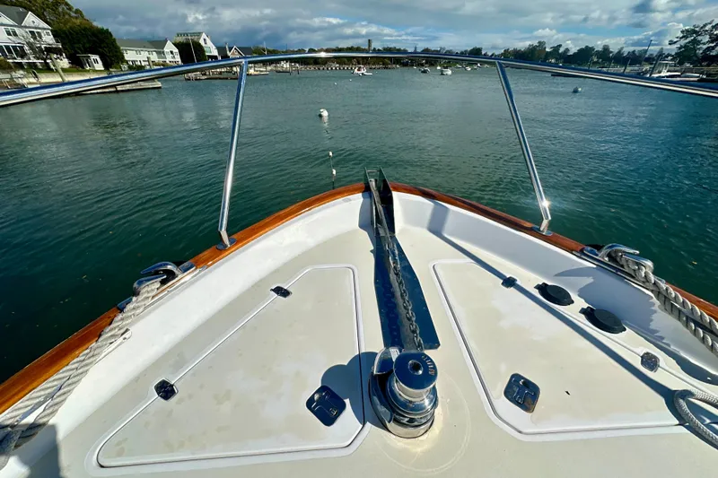 Belle Yacht Photos Pics Bow view of 2007 Legacy Yachts 34 Sport Express in a serene harbor setting.