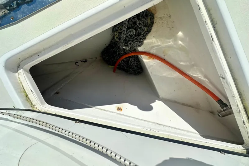 Belle Yacht Photos Pics Anchor locker of 2007 Legacy Yachts 34 Sport Express with chain and orange hose.