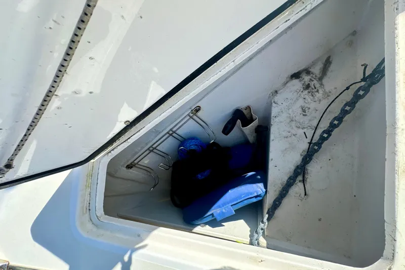 Belle Yacht Photos Pics Open storage compartment on 2007 Legacy Yachts 34 Sport Express with anchor chain and gear.