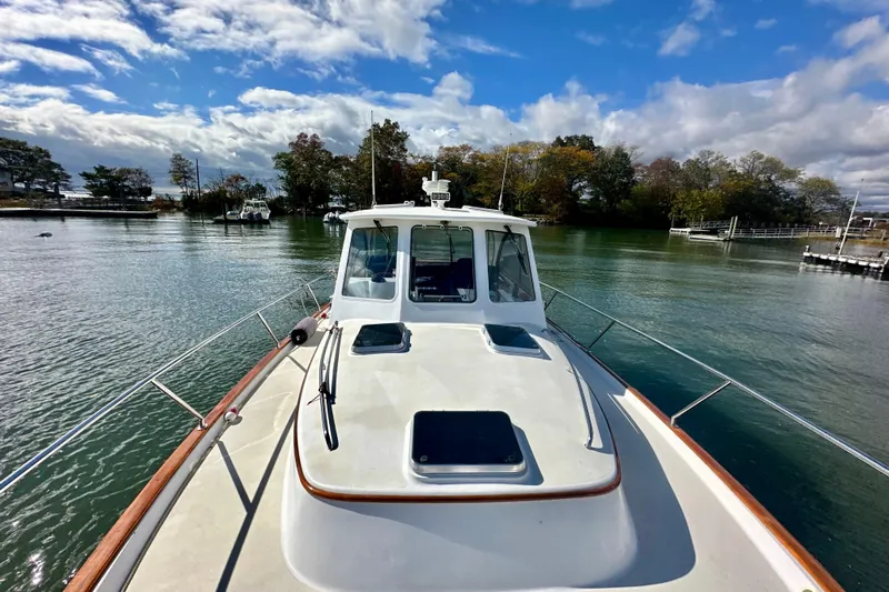 Belle Yacht Photos Pics 2007 Legacy Yachts 34 Sport Express on calm water under a partly cloudy sky.