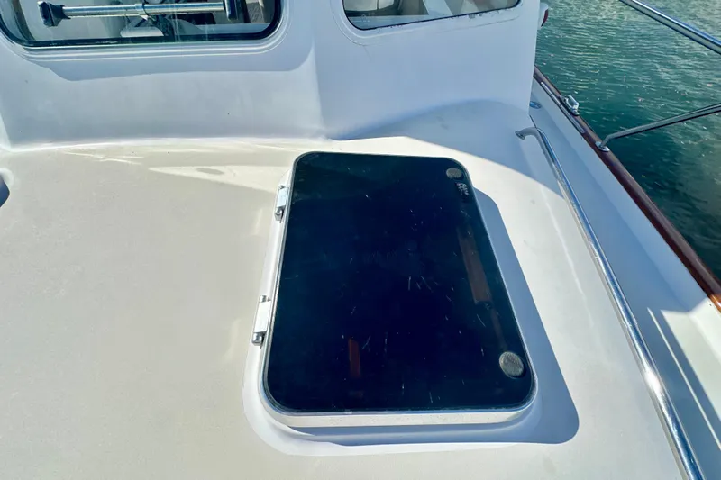 Belle Yacht Photos Pics 2007 Legacy Yachts 34 Sport Express deck hatch with railing and window view.