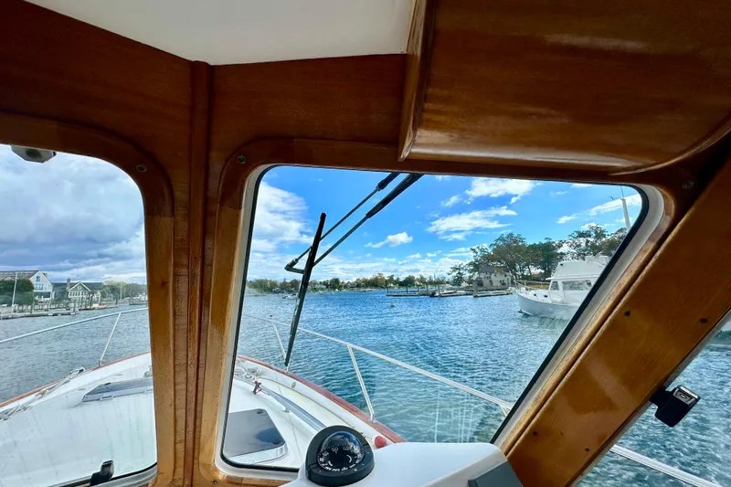 Belle Yacht Photos Pics 2007 Legacy Yachts 34 Sport Express view from cabin, overlooking serene waters and distant shoreline.