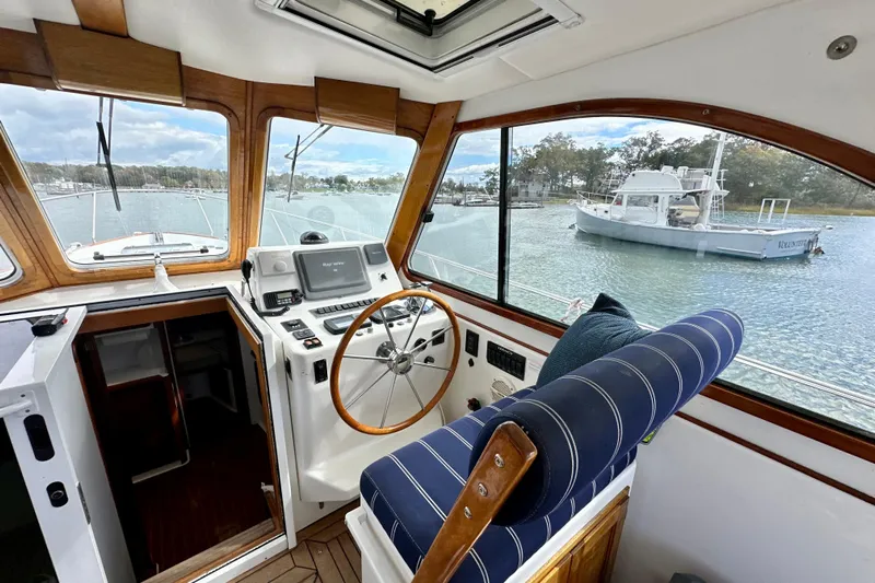 Belle Yacht Photos Pics Interior view of 2007 Legacy Yachts 34 Sport Express, featuring helm and scenic waterway.