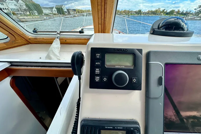 Belle Yacht Photos Pics 2007 Legacy Yachts 34 Sport Express helm with Simrad navigation system, dockside view.