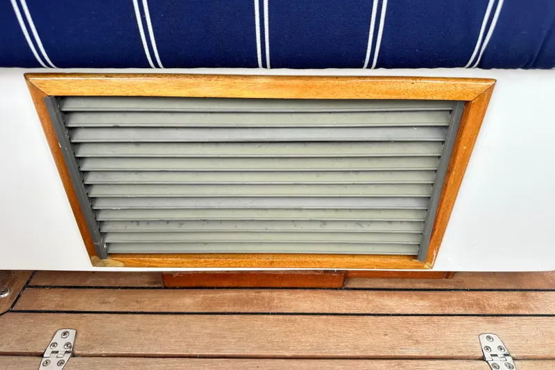 Belle Yacht Photos Pics Wooden-framed vent on 2007 Legacy Yachts 34 Sport Express, with striped upholstery and teak flooring.