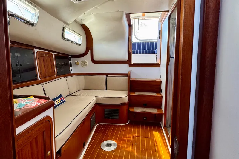 Belle Yacht Photos Pics Interior of 2007 Legacy Yachts 34 Sport Express with wooden finish and beige seating.