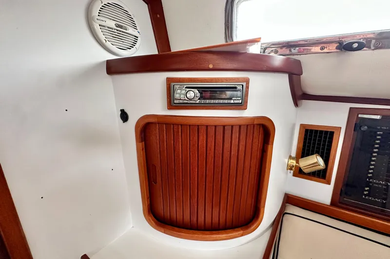 Belle Yacht Photos Pics 2007 Legacy Yachts 34 Sport Express interior with wood paneling and audio system.