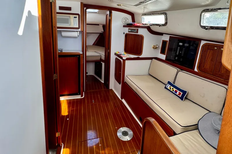 Belle Yacht Photos Pics Interior of 2007 Legacy Yachts 34 Sport Express with wood finish and cozy seating.