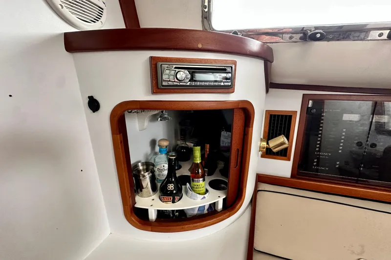 Belle Yacht Photos Pics 2007 Legacy Yachts 34 Sport Express interior with bar cabinet and stereo system.