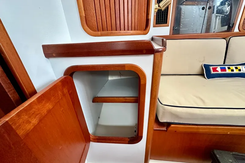 Belle Yacht Photos Pics Interior of 2007 Legacy Yachts 34 Sport Express with wooden cabinetry and seating.