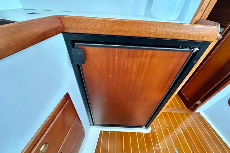 Belle Yacht Photos Pics 2007 Legacy Yachts 34 Sport Express interior with wooden cabinetry and flooring.