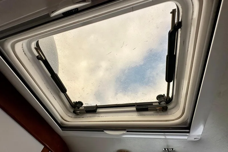 Belle Yacht Photos Pics Hatch window view from 2007 Legacy Yachts 34 Sport Express, showing sky and clouds.