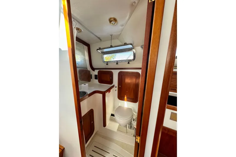 Belle Yacht Photos Pics 2007 Legacy Yachts 34 Sport Express bathroom with wooden accents and compact design.