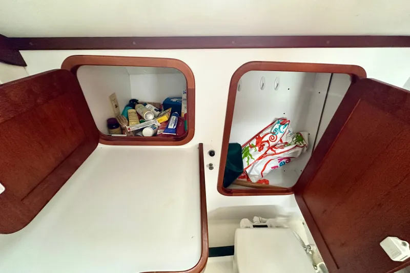 Belle Yacht Photos Pics 2007 Legacy Yachts 34 Sport Express interior storage with open wooden cabinets.