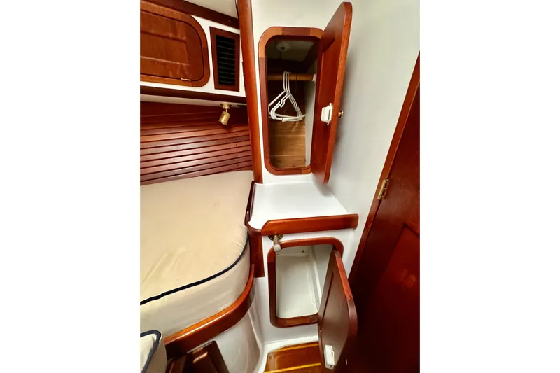 Belle Yacht Photos Pics 2007 Legacy Yachts 34 Sport Express cabin interior with wooden cabinetry and storage.