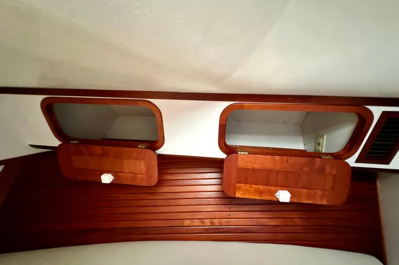 Belle Yacht Photos Pics Interior of 2007 Legacy Yachts 34 Sport Express with wooden cabinets and white walls.