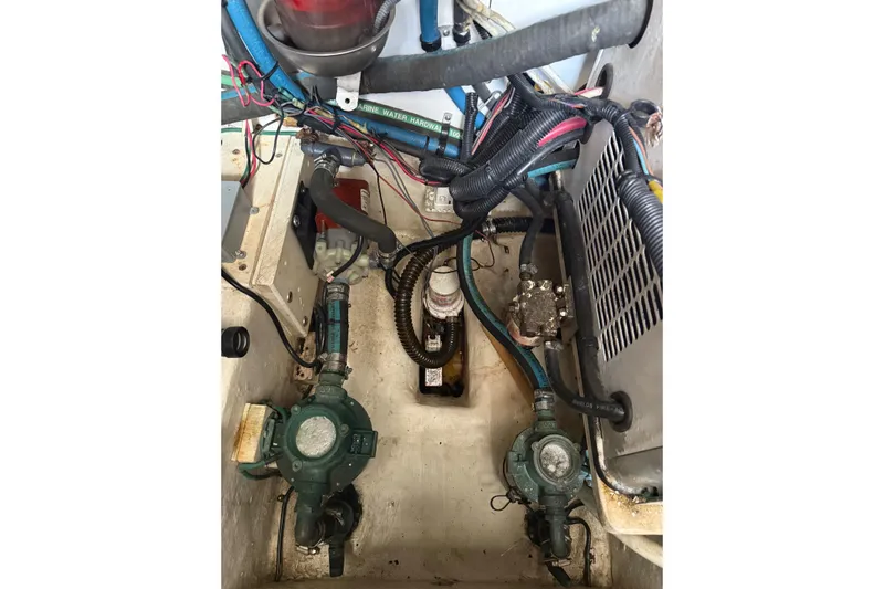 Belle Yacht Photos Pics Engine compartment of 2007 Legacy Yachts 34 Sport Express, showing mechanical components and wiring.