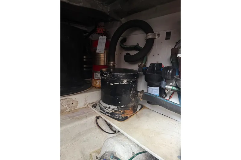 Belle Yacht Photos Pics Engine compartment of 2007 Legacy Yachts 34 Sport Express, showing mechanical components and hoses.