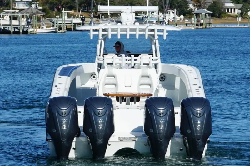  Yacht Photos Pics 2024 Freeman 38 boat with four powerful outboard engines on a calm waterway.