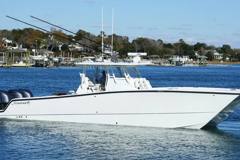  Yacht Photos Pics 2024 Freeman 38 boat cruising on a calm blue waterway.