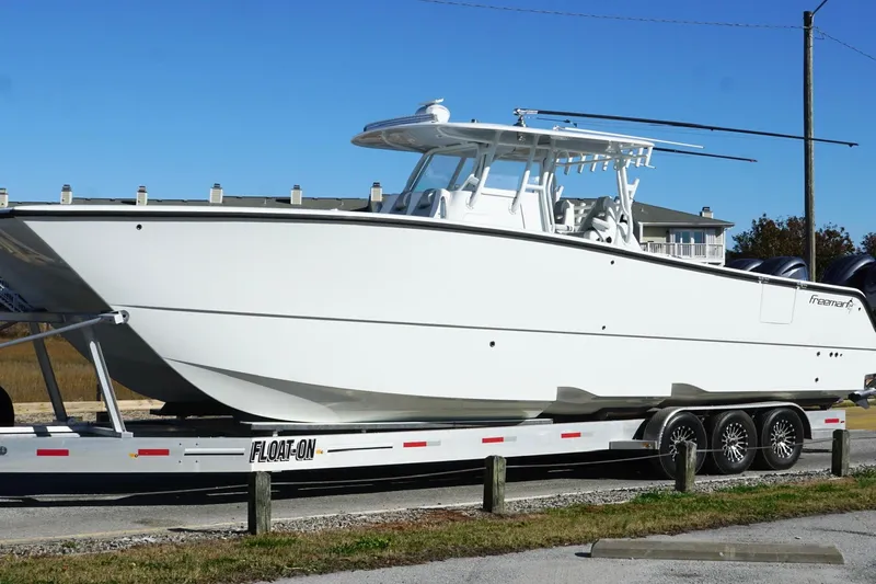  Yacht Photos Pics 2024 Freeman 38 boat on trailer, sleek design, ready for adventure.