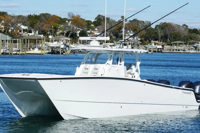  Yacht Photos Pics 2024 Freeman 38 boat on water, featuring sleek design and multiple engines.