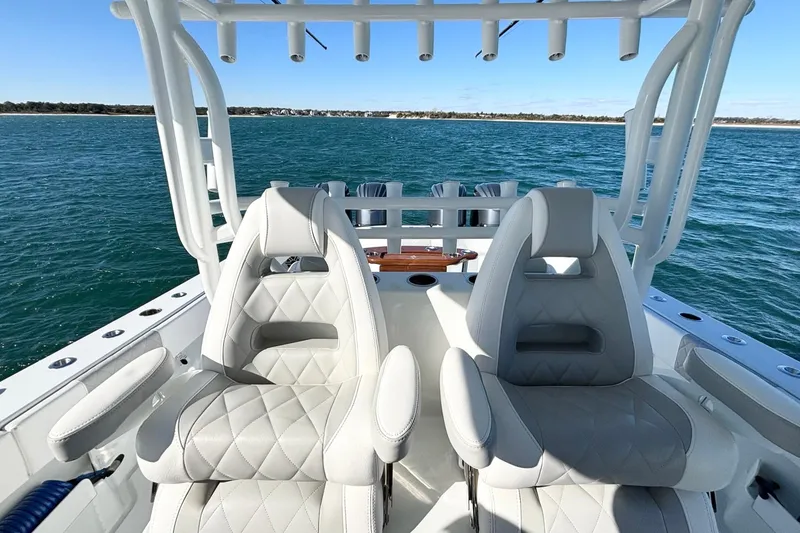  Yacht Photos Pics Luxury seating on a 2024 Freeman 38 boat, overlooking serene ocean waters.