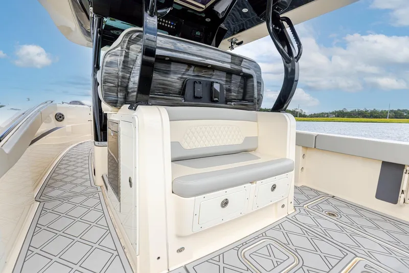 Your Next Boat! Yacht Photos Pics 2024 Scout 377 LXF boat interior with seating and storage, featuring elegant design and water view.
