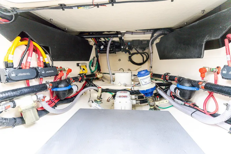 Your Next Boat! Yacht Photos Pics 2024 Scout 377 LXF boat wiring and plumbing system, showcasing organized cables and components.