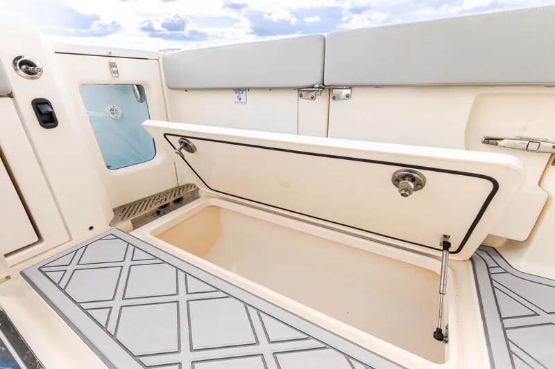 Your Next Boat! Yacht Photos Pics 2024 Scout 377 LXF boat storage compartment with open hatch, showcasing interior design.