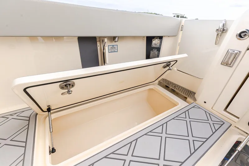 Your Next Boat! Yacht Photos Pics 2024 Scout 377 LXF boat storage compartment with open lid, showcasing interior design.