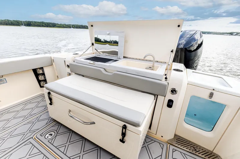 Your Next Boat! Yacht Photos Pics 2024 Scout 377 LXF boat interior with Summer Kitchen Upgrade featuring Electric Grill, Sink, Cutting Board and Slide out Cooler/Seat