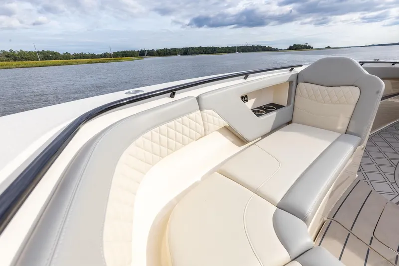 Your Next Boat! Yacht Photos Pics Luxurious seating on 2024 Scout 377 LXF boat, featuring elegant design and waterfront view.