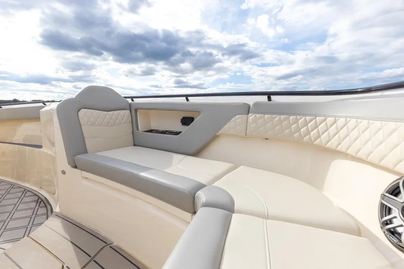 Your Next Boat! Yacht Photos Pics 2024 Scout 377 LXF boat interior with luxurious seating and elegant design under a cloudy sky.