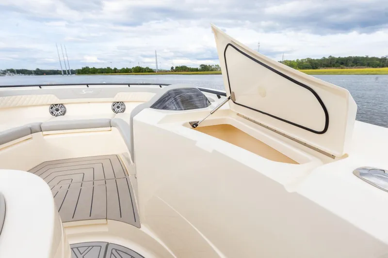 Your Next Boat! Yacht Photos Pics 2024 Scout 377 LXF boat interior with open storage compartment and seating area.