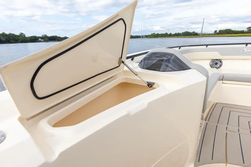Your Next Boat! Yacht Photos Pics 2024 Scout 377 LXF boat with open storage compartment, luxurious seating, and scenic water view.