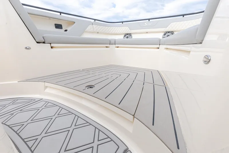 Your Next Boat! Yacht Photos Pics 2024 Scout 377 LXF boat interior with cushioned seating and stylish flooring.