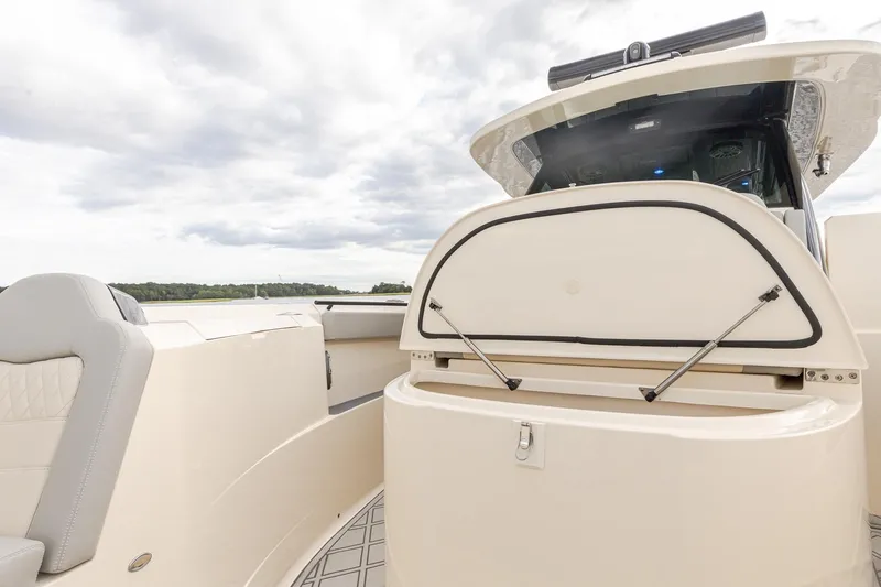 Your Next Boat! Yacht Photos Pics 2024 Scout 377 LXF boat interior with open storage compartment under Sunpad