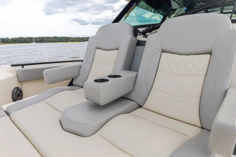 Your Next Boat! Yacht Photos Pics Luxurious seating on 2024 Scout 377 LXF boat with cup holders, on a scenic waterway.